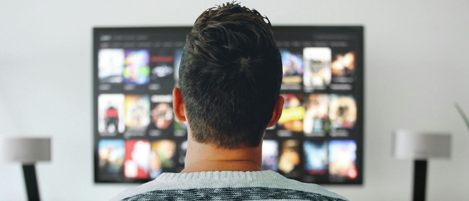 Watch TV clearly with Bluetooth hearing aids and a compatible transmitter | Aanvii Hearing Bluetooth hearing aids connected to TV using a transmitter for clear sound experience